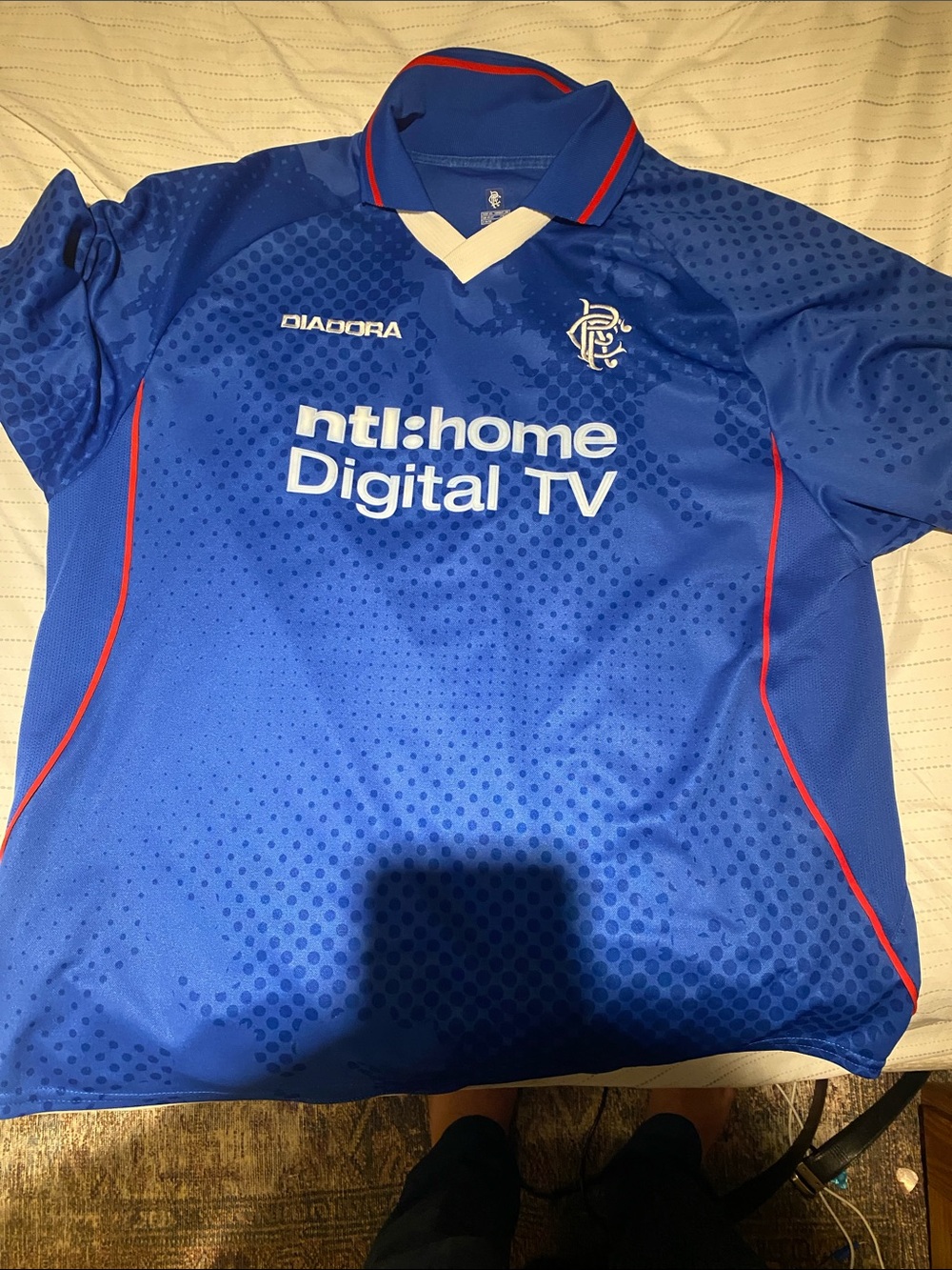 Diadora Blue Soccer Jersey with Red Trim and White Sponsor Logo